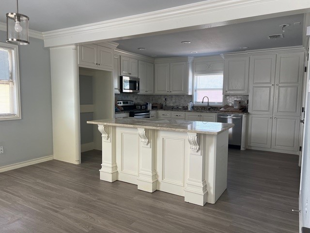 5375 County Road 73A, Unit 2 Robstown, TX 78380 - Photo 4 of 14 a kitchen with white cabinets and stainless steel appliances