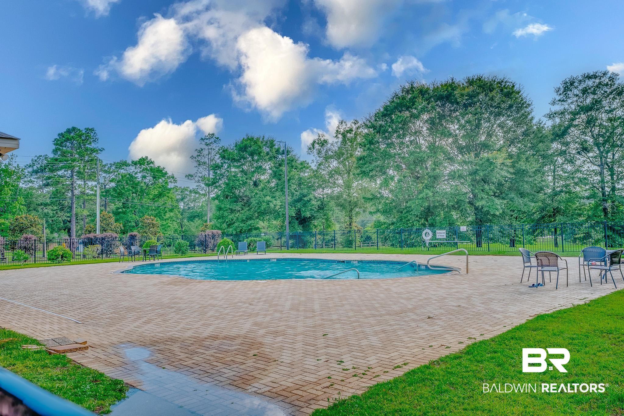 8242 Sycamore Way Semmes, AL 36575 - Photo 39 of 43 Community pool with a patio area and view of scattered trees