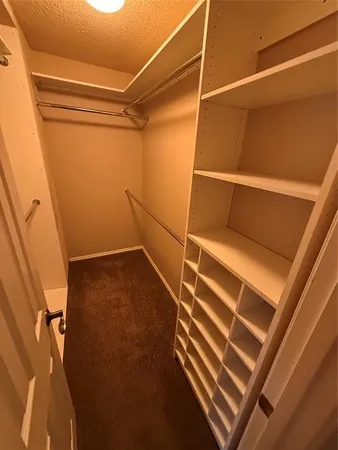 an empty room with a ceiling fan and a window