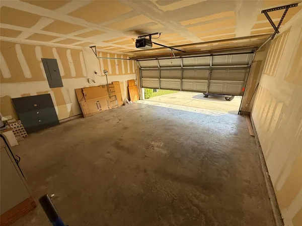 a view of an empty room and chandelier fan