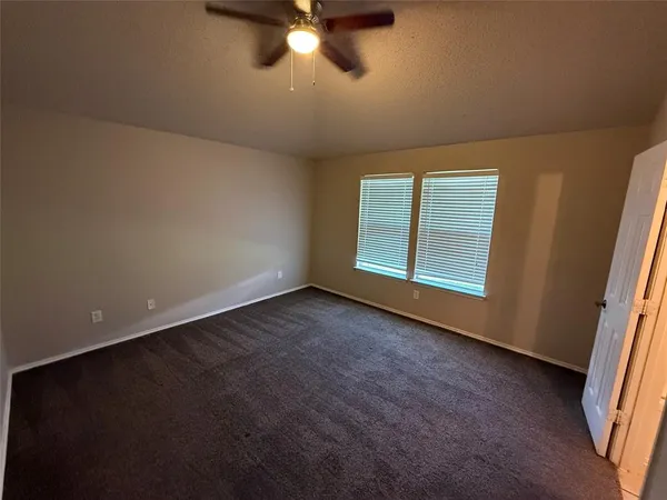 a bathroom with a granite countertop toilet sink and mirror