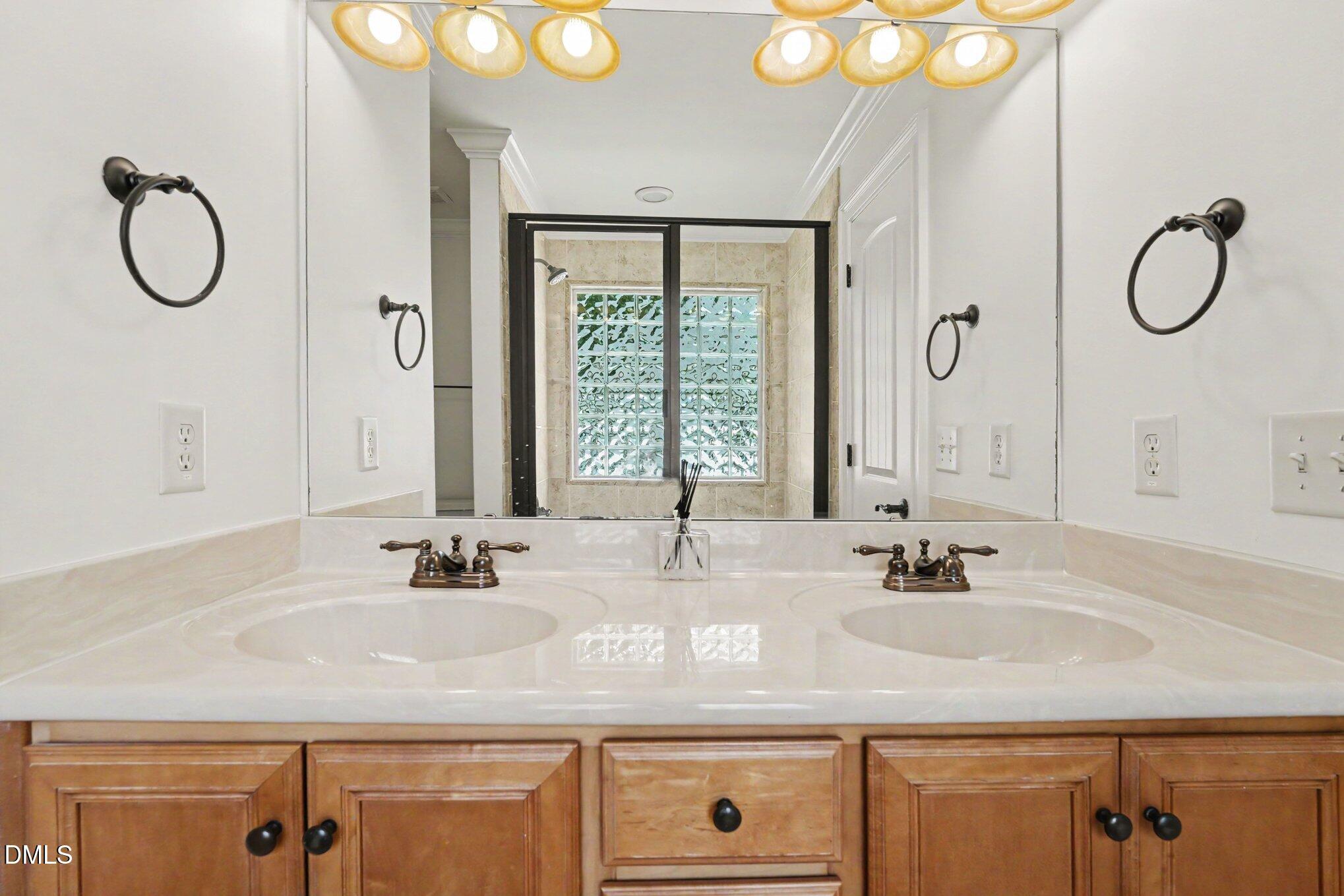1729 Frenchwood Drive Raleigh, NC 27612 - Photo 30 of 46 a bathroom with a granite countertop sink and a mirror