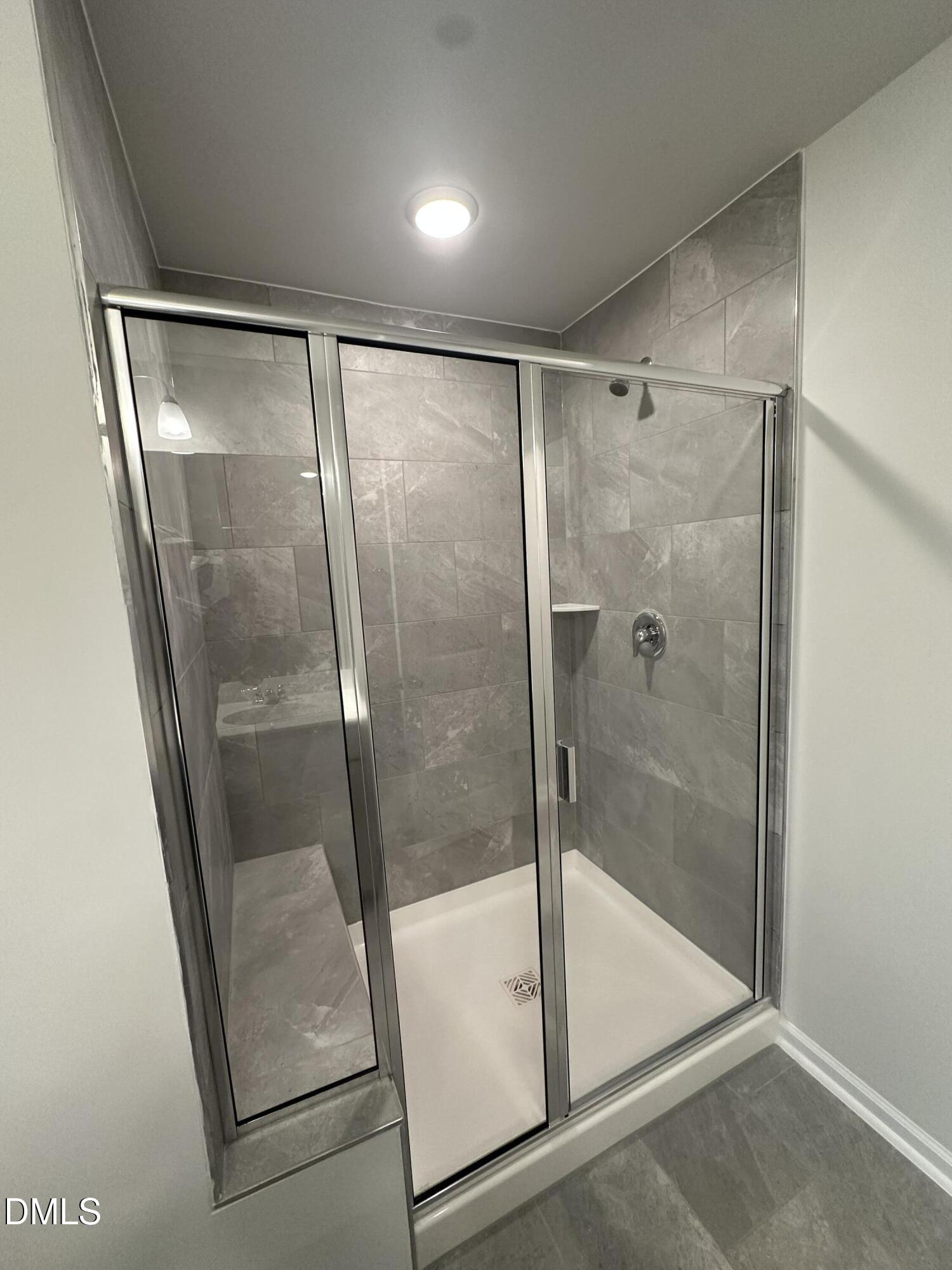 295 Glenmore Gardens Road Raleigh, NC 27603 - Photo 18 of 30 a bathroom with a glass shower door