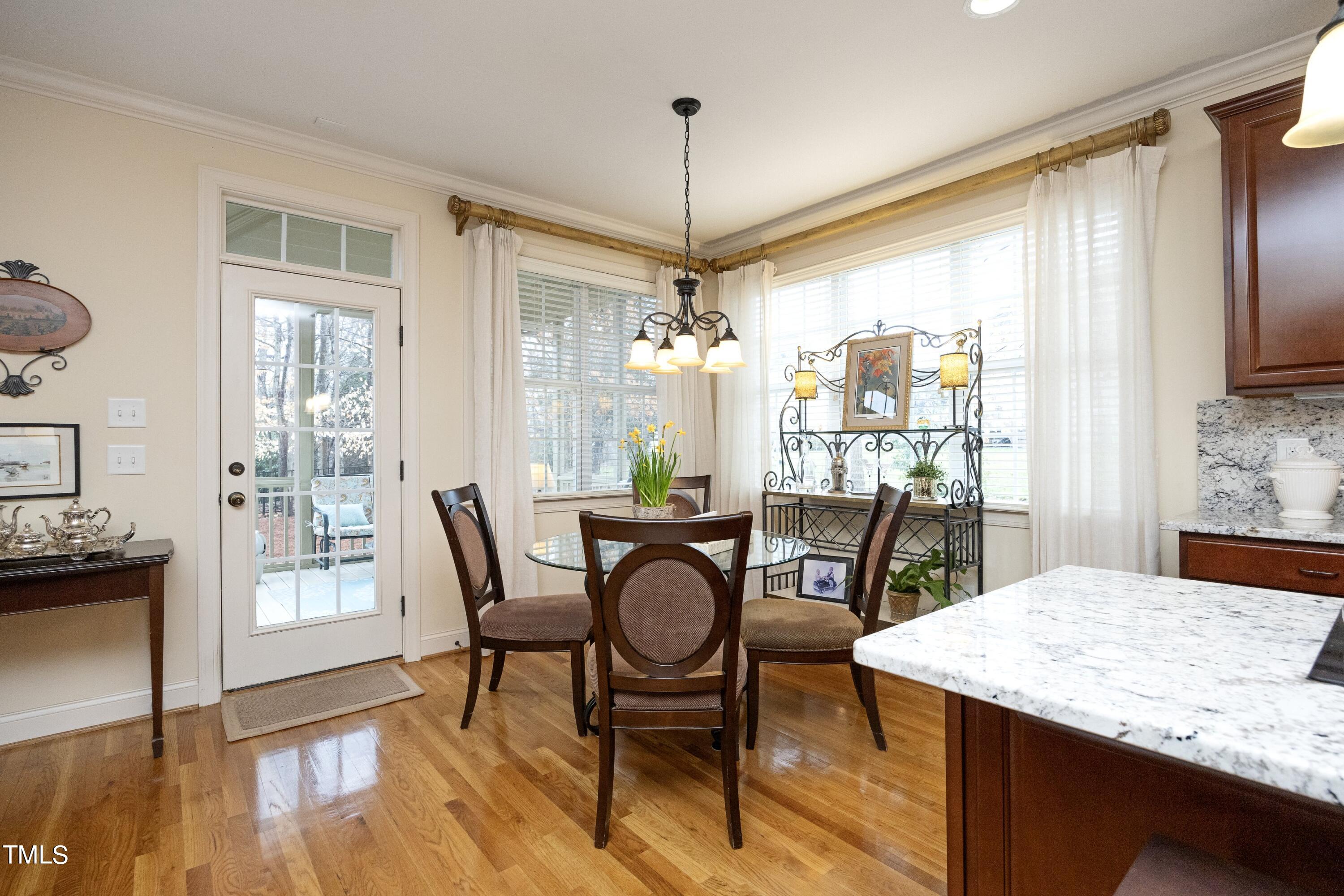 11514 Autumn Oaks Lane Raleigh, NC 27614 - Photo 17 of 39 a view of a dining room with furniture window and wooden floor