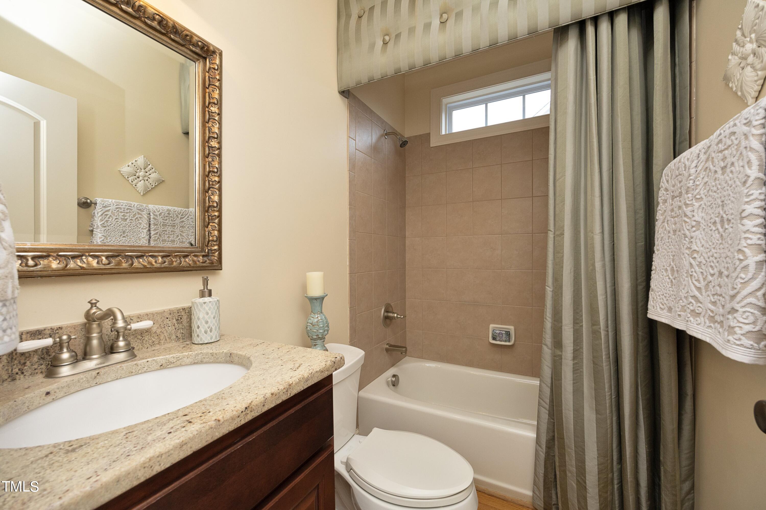 11514 Autumn Oaks Lane Raleigh, NC 27614 - Photo 19 of 39 a bathroom with a granite countertop sink toilet tub and shower