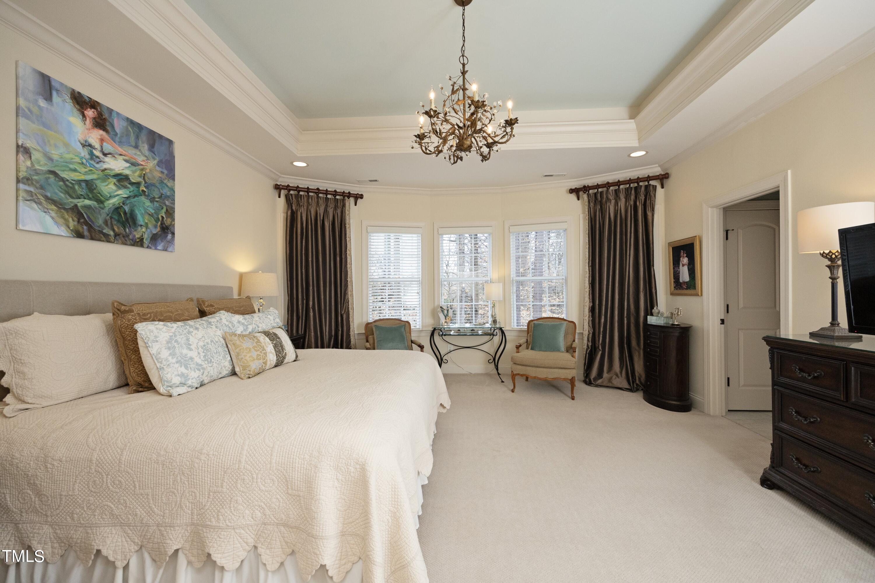 11514 Autumn Oaks Lane Raleigh, NC 27614 - Photo 22 of 39 a bedroom with a balcony a bed and furniture