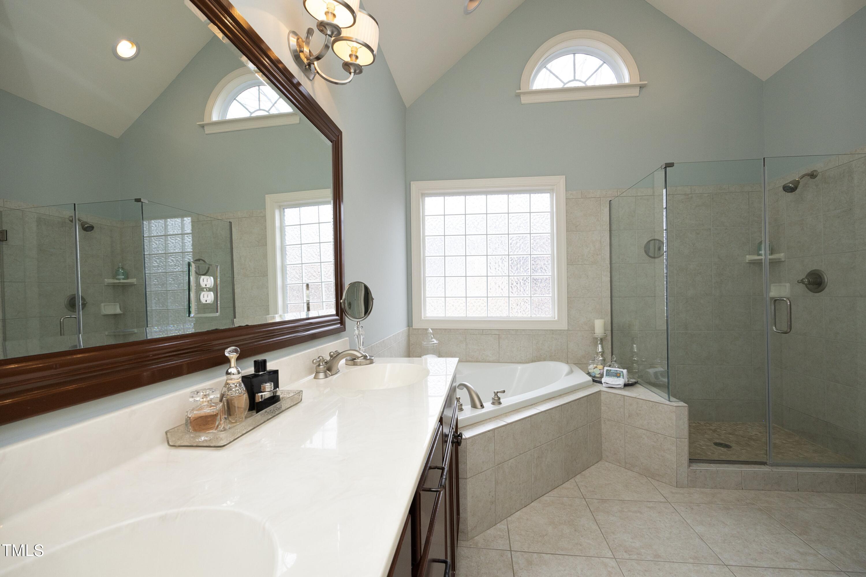 11514 Autumn Oaks Lane Raleigh, NC 27614 - Photo 25 of 39 a bathroom with a tub sink and mirror