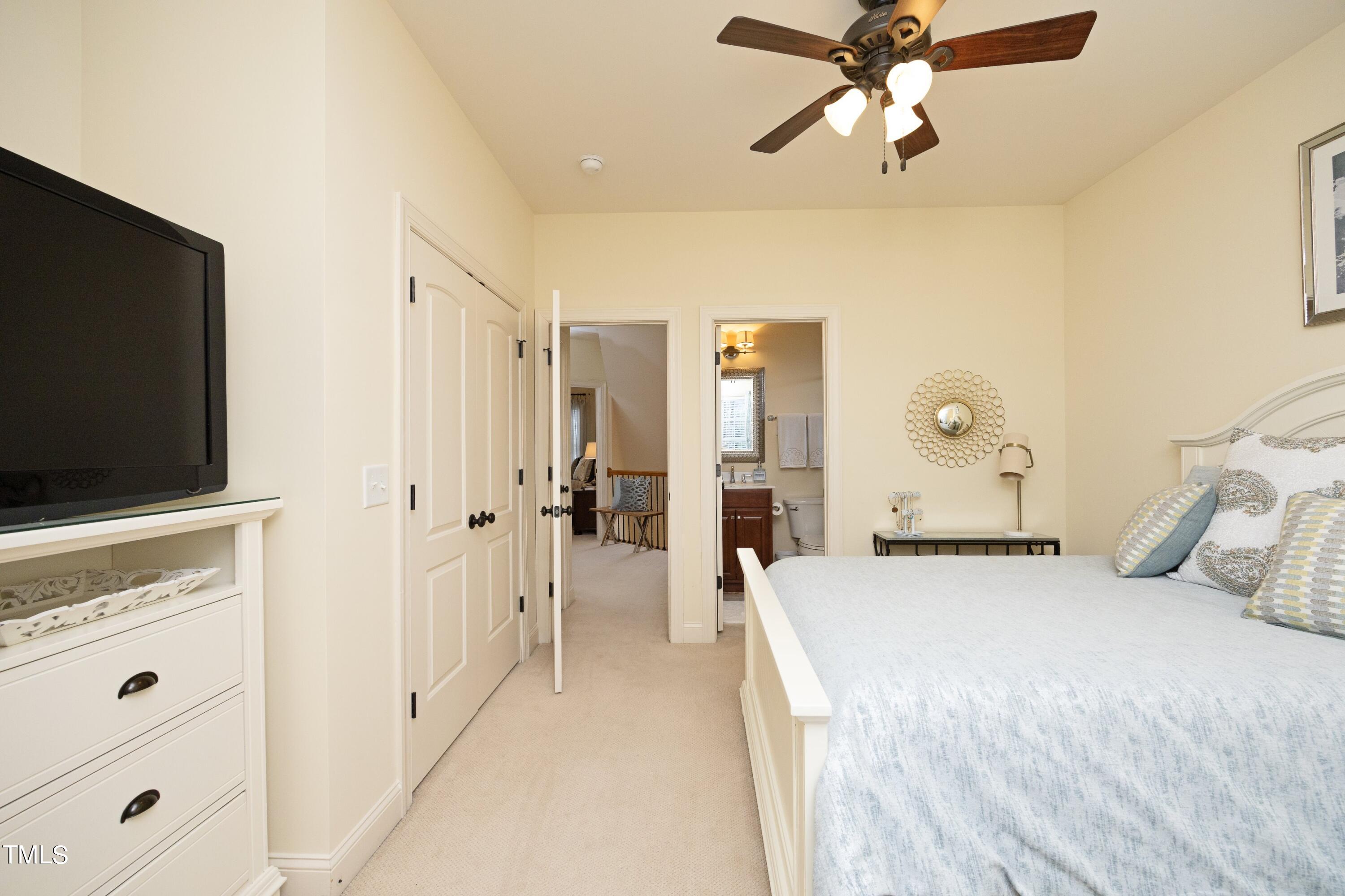 11514 Autumn Oaks Lane Raleigh, NC 27614 - Photo 31 of 39 a bedroom with a bed and a flat screen tv