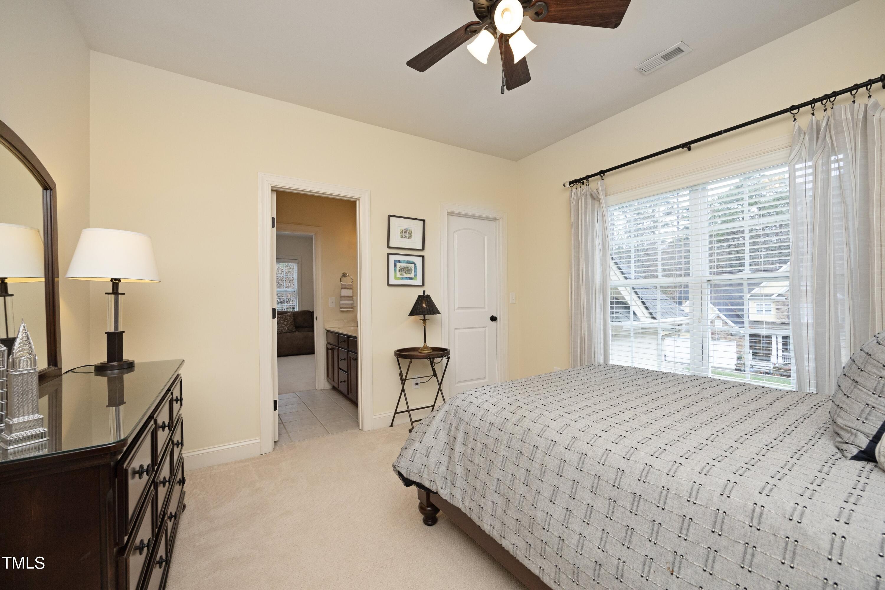 11514 Autumn Oaks Lane Raleigh, NC 27614 - Photo 32 of 39 a bedroom with a bed and a chandelier