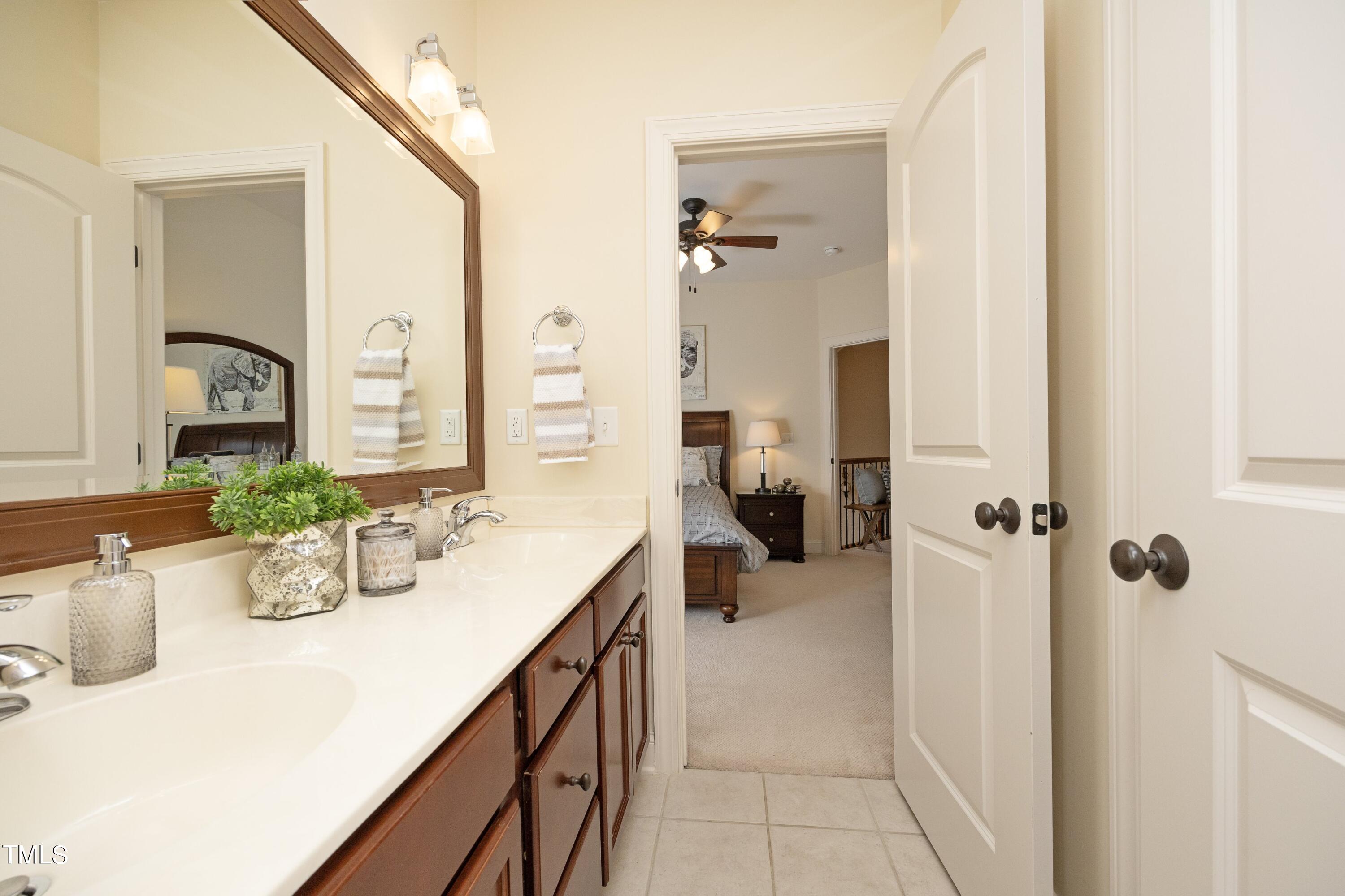 11514 Autumn Oaks Lane Raleigh, NC 27614 - Photo 33 of 39 a bathroom with a sink a mirror and a shower