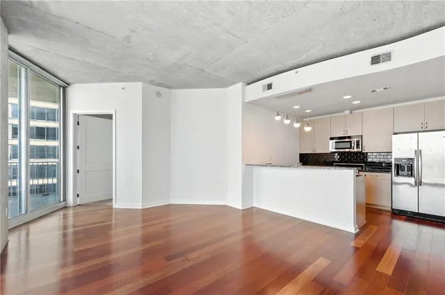 a view of kitchen with stainless steel appliances a refrigerator and a stove top oven
