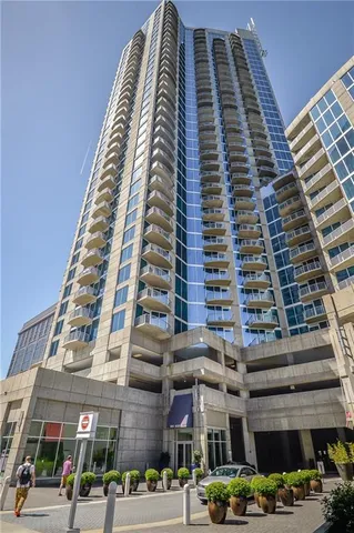 a row of palm trees sitting in front of a building