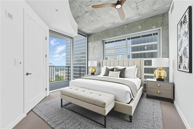 a spacious bedroom with a bed and a window