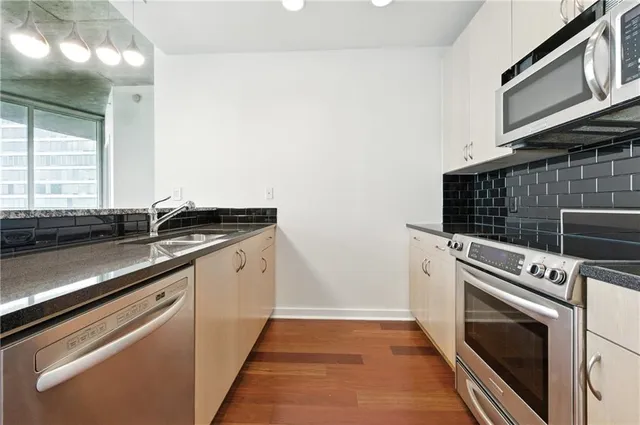 a kitchen with a sink stove and microwave