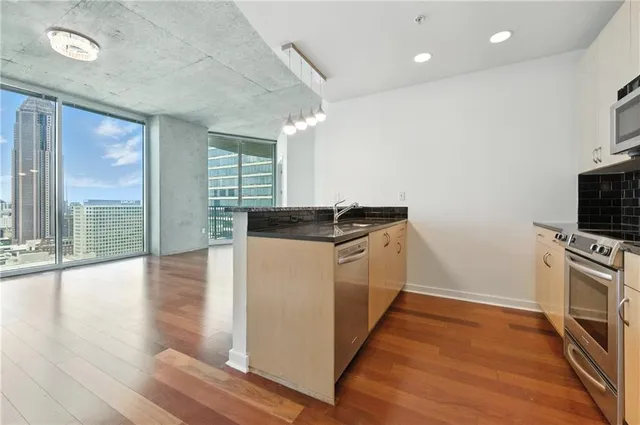 a view of a kitchen with wooden floor and a sink