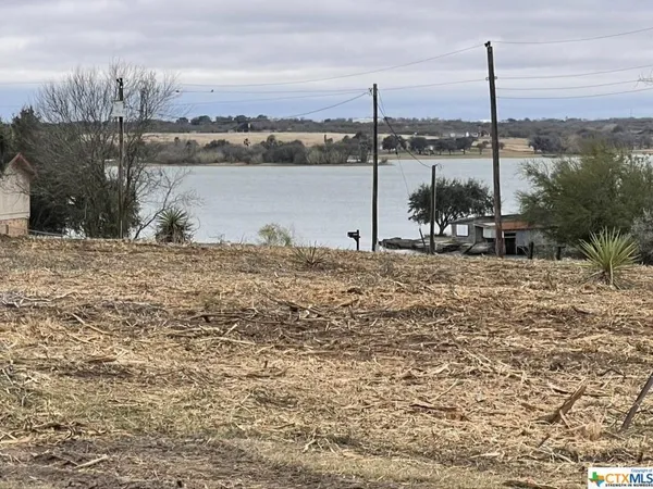 a large body of water with a building in the background