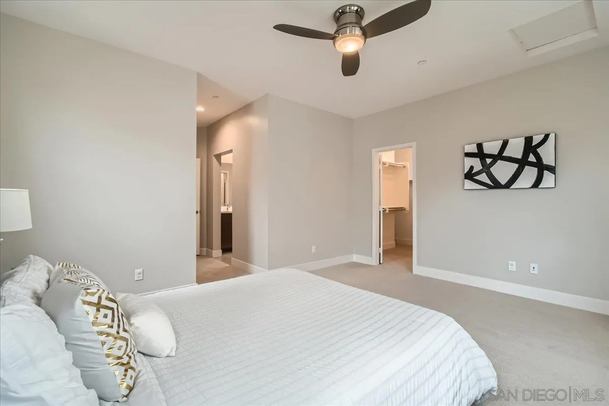 2290 Element Way Chula Vista, CA 91915 - Photo 13 of 34 a bedroom with a large bed and a chandelier