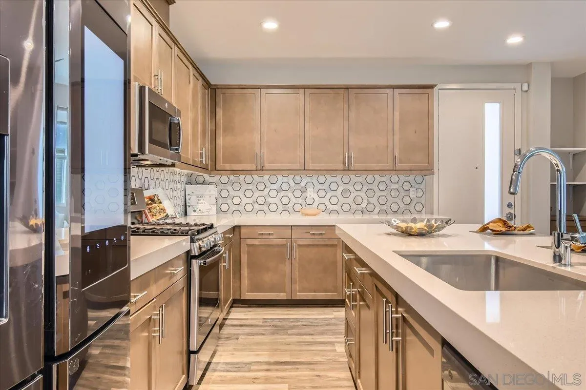 2290 Element Way Chula Vista, CA 91915 - Photo 7 of 34 a kitchen with a sink stove and cabinets
