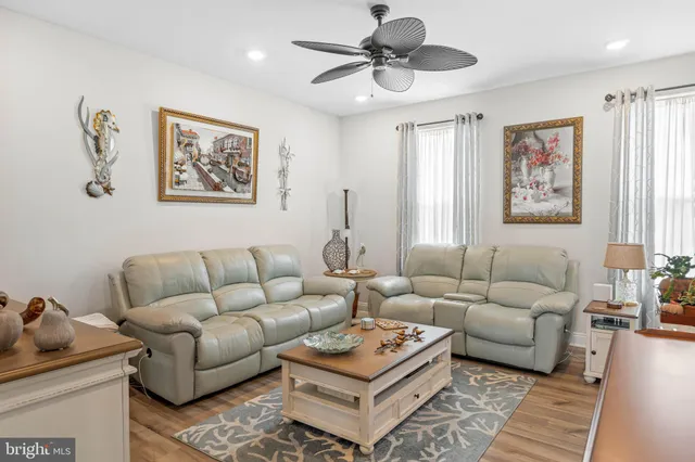 a living room with furniture a rug and a window