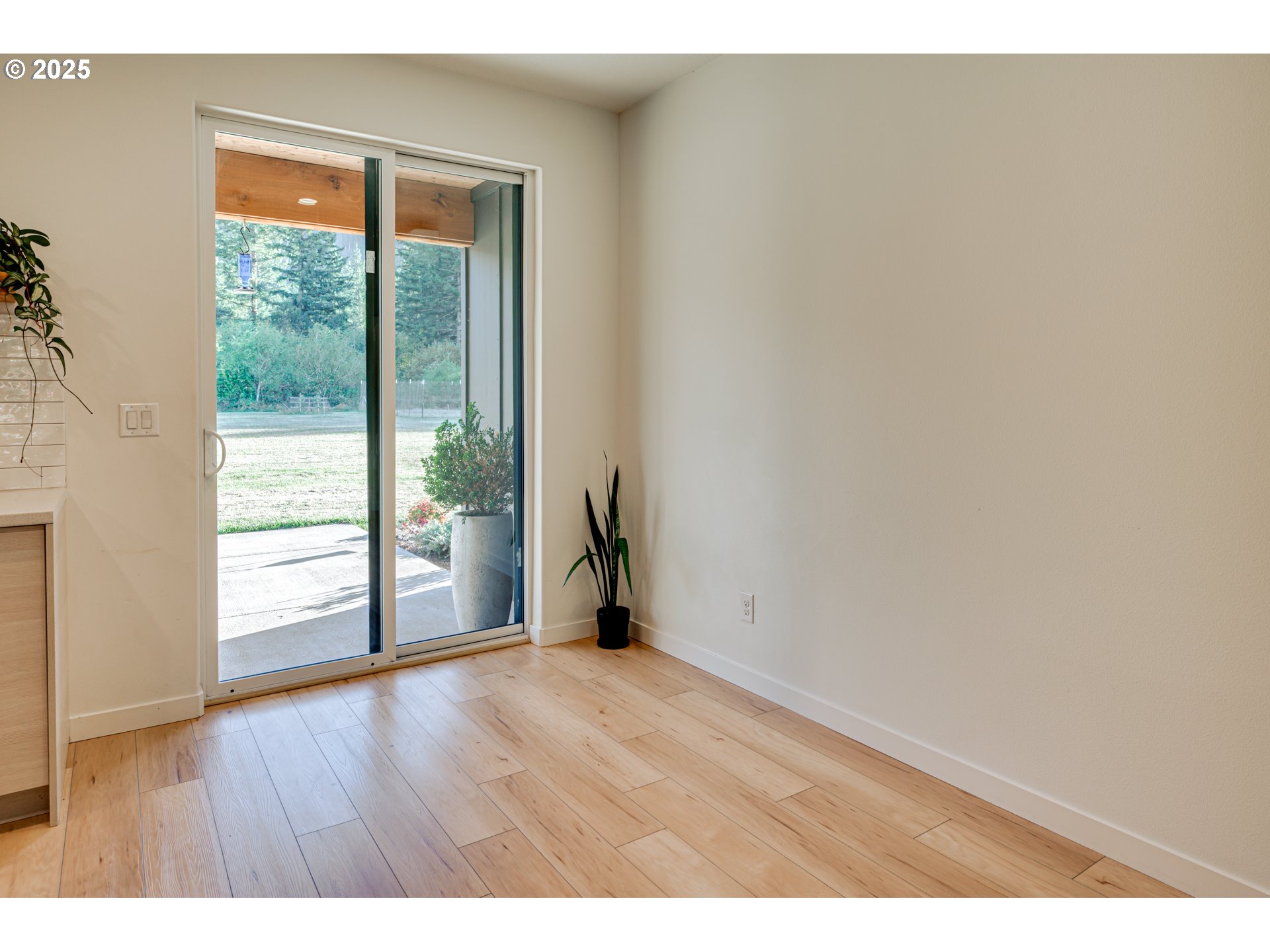 192 Stuart Field Lane Ariel, WA 98603 - Photo 11 of 35 a view of an empty room with wooden floor and a window