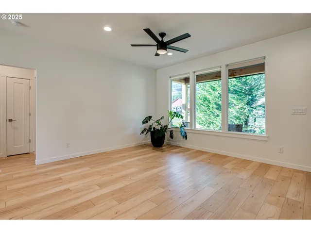 a view of a livingroom with a ceiling fan and window