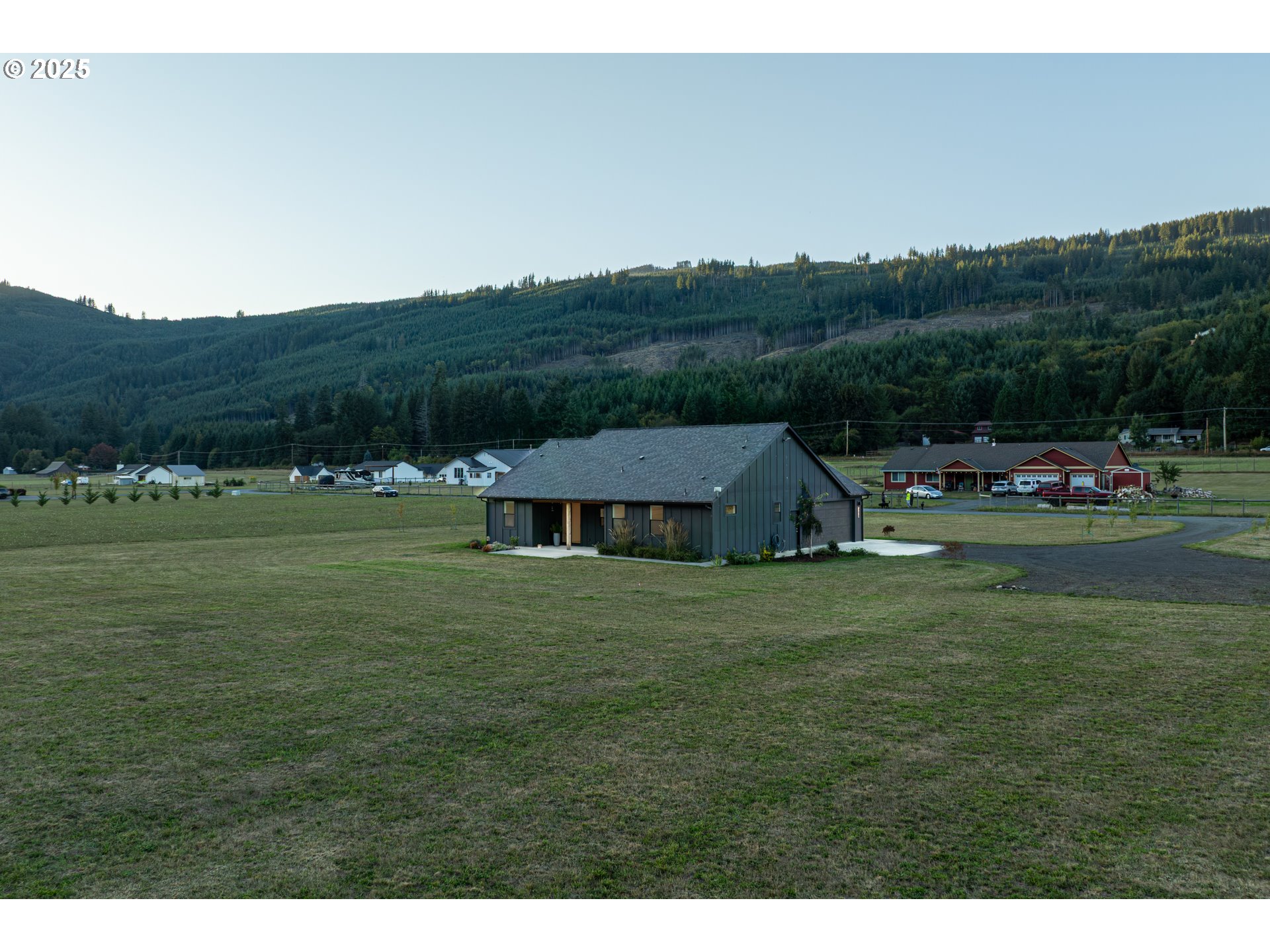 192 Stuart Field Lane Ariel, WA 98603 - Photo 31 of 35 a view of a big house with a big yard and large trees