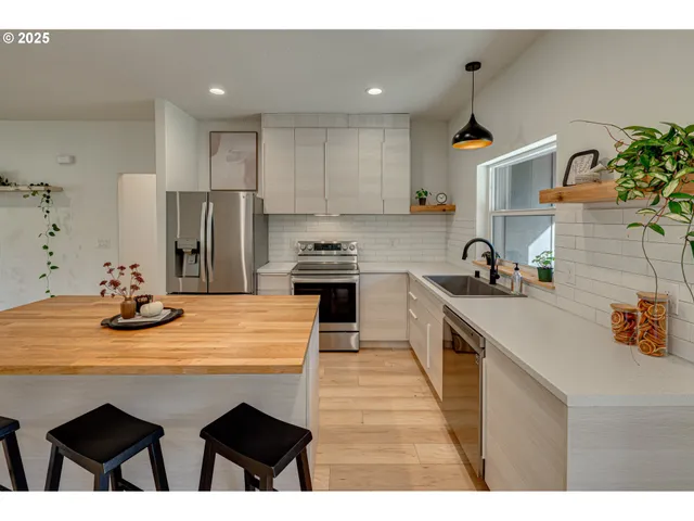 a kitchen with refrigerator and cabinets