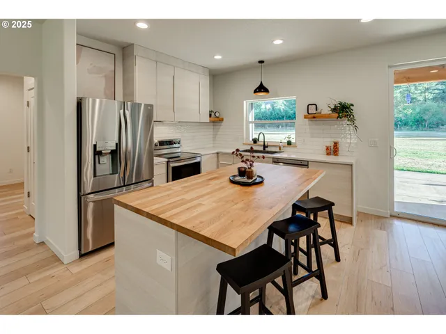 a kitchen with a table and chairs in it
