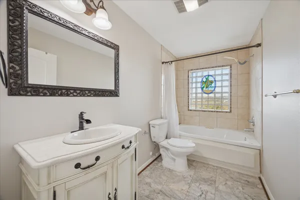 a bathroom with a sink toilet a mirror and shower