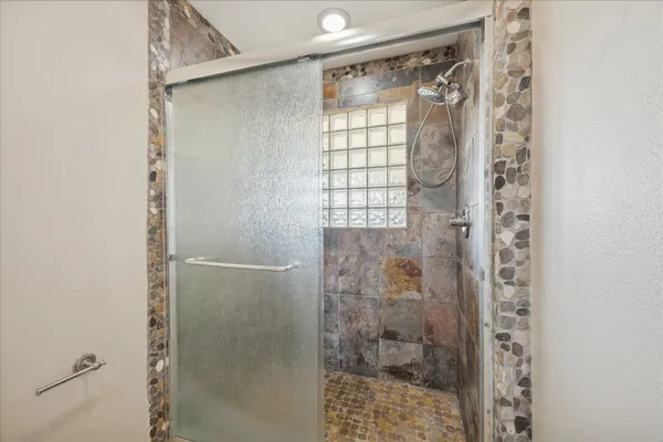 a bathroom with a glass shower door