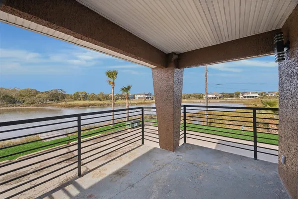 a view of a balcony with furniture and a gate
