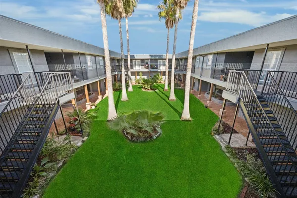 a view of an house with backyard and deck