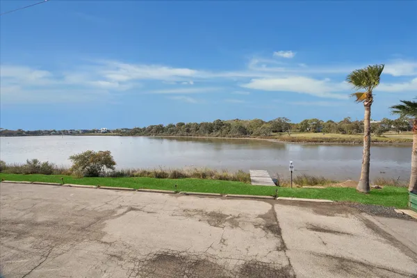 a view of a lake with houses in the background