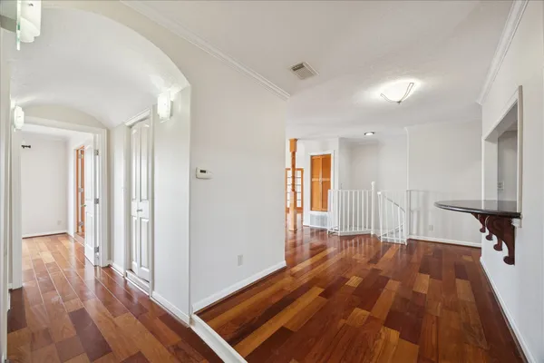 a view of a room with wooden floor and stairs