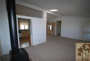 59350 Rocky Ravine Road Anza, CA 92539 - Photo 6 of 15 a view of a hallway with wooden floor and a livingroom