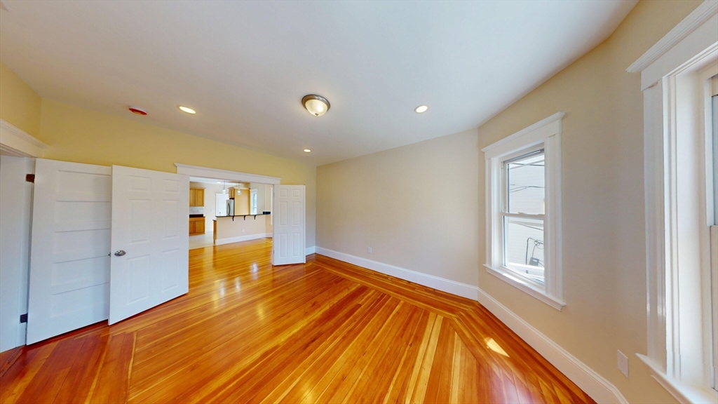 27 Champney Street, Unit 2 Boston, MA 02135 - Photo 2 of 12 a bedroom with a bed and a window