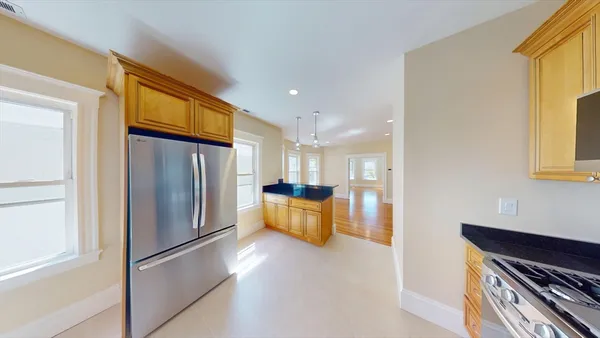 a kitchen with a refrigerator and a stove top oven