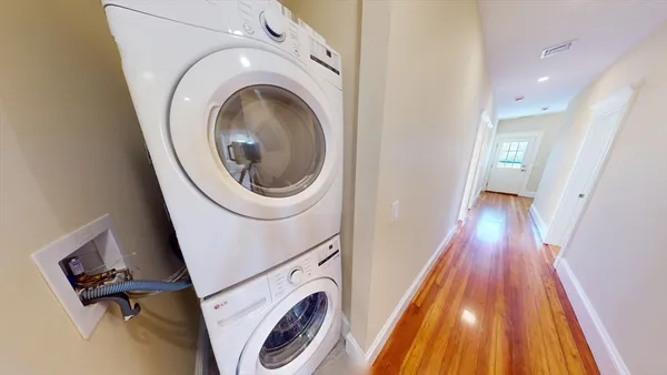 a view of a hallway with washer and dryer