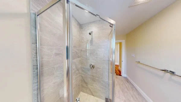 a bathroom with a glass shower door