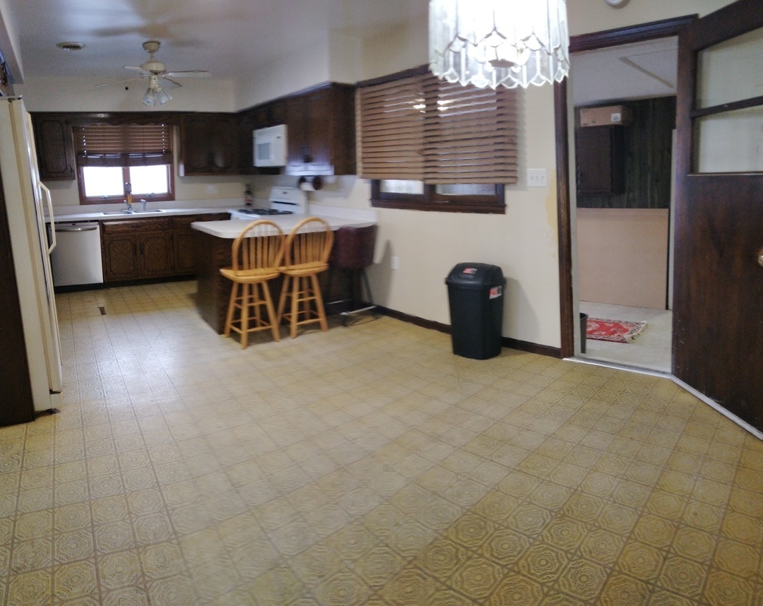 2201 Root Street Crest Hill, IL 60403 - Photo 7 of 27 a kitchen with a sink and a refrigerator