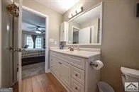 a bathroom with a granite countertop sink mirror and vanity