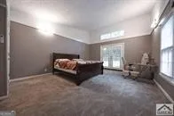 a spacious bedroom with a bed and a couch