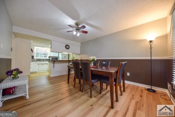 a view of a dining room with furniture and wooden floor