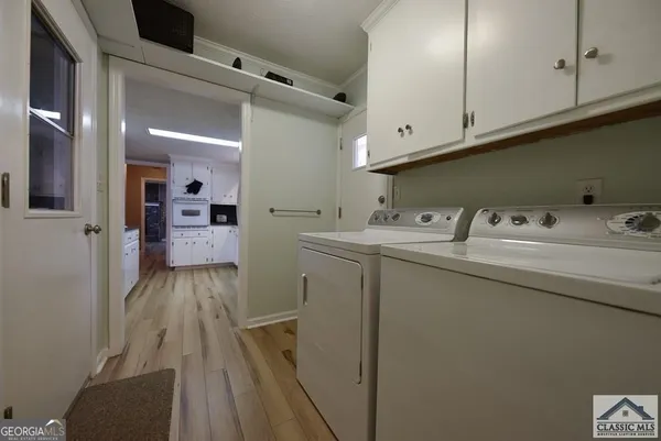 a utility room with cabinets washer and dryer