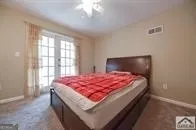 a bed sitting in a bedroom next to a window