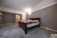 a bedroom with a bed and a night stand