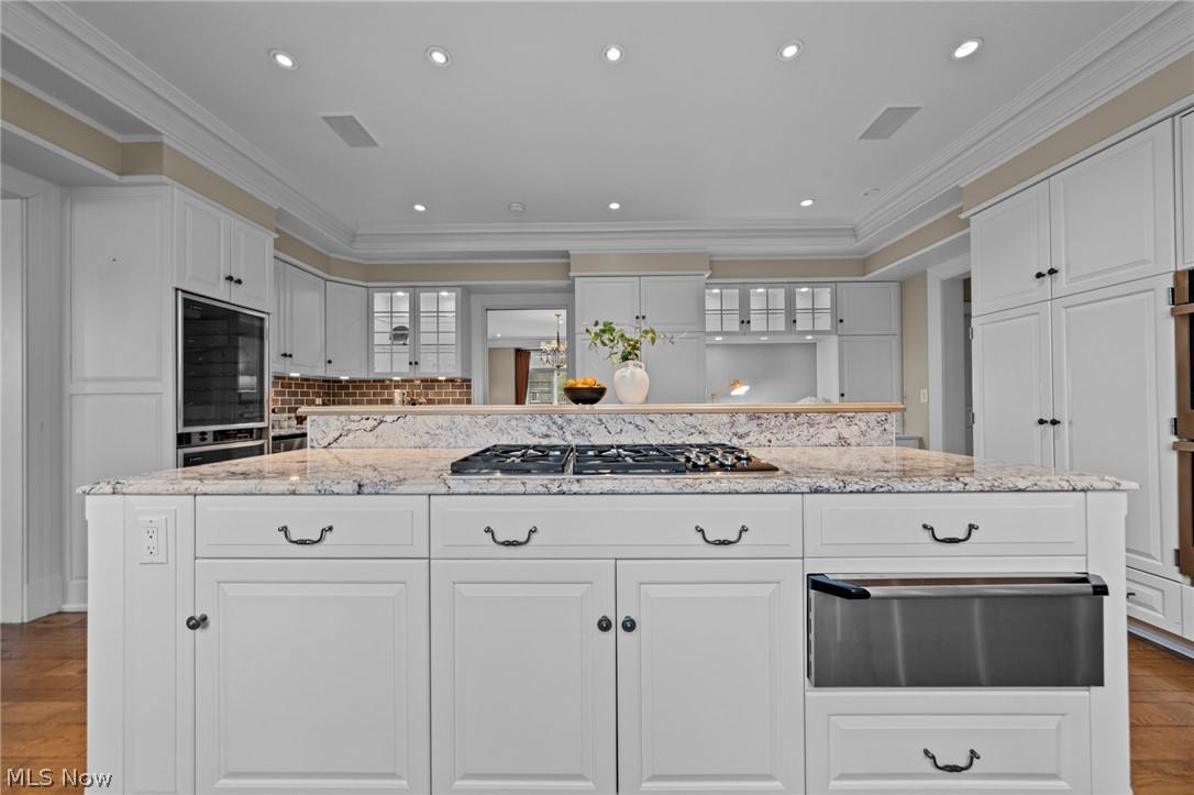 31900 Pinetree Road Pepper Pike, OH 44124 - Photo 14 of 43 With double ovens, built-in microwave, five burner cooktop and warming drawer, meal prep feels easy. Display your favorite pieces in the glass front cabinets and hide the more mundane items in the endless, closed kitchen storage.