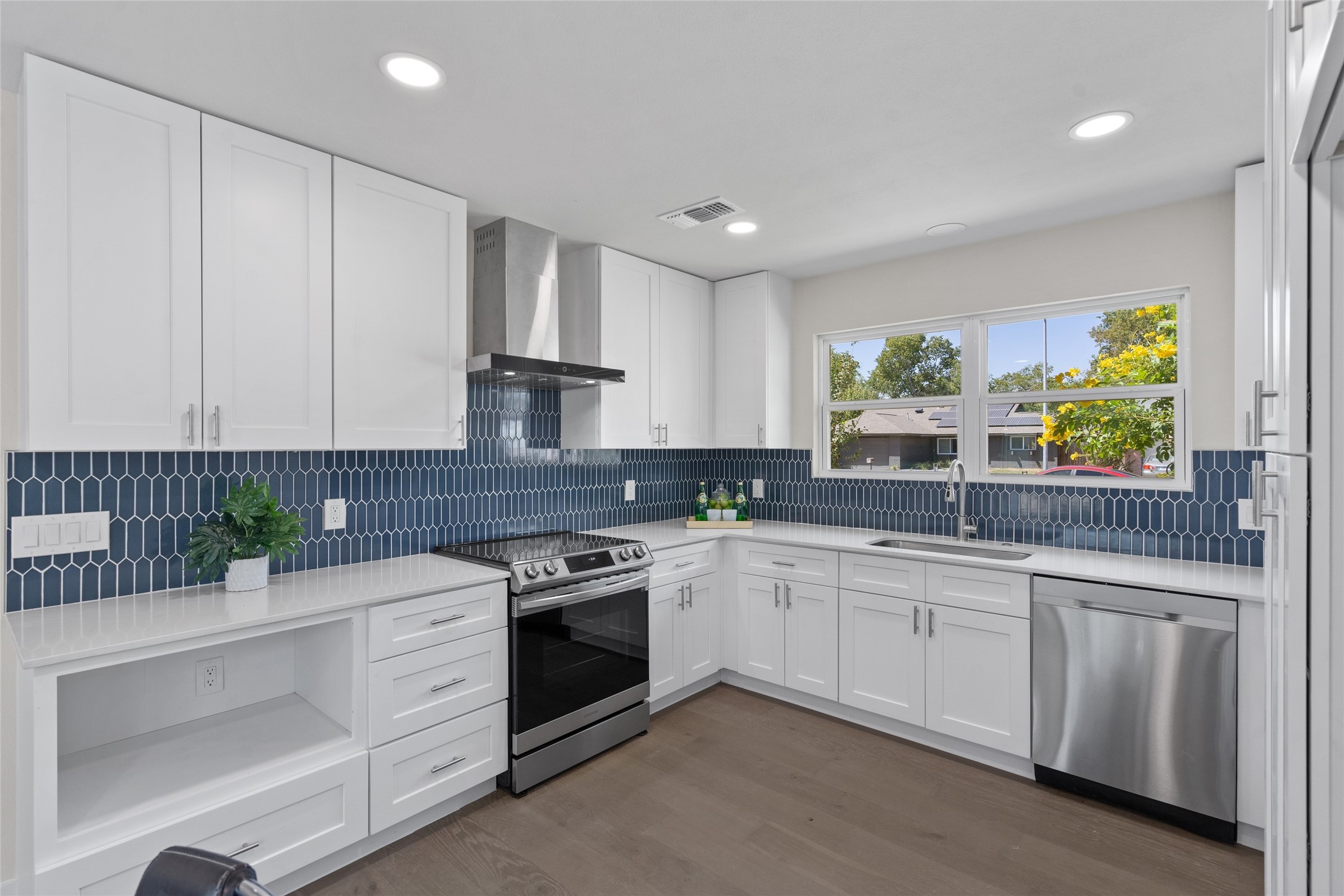 6901 Windrift Way Austin, TX 78745 - Photo 23 of 30 a kitchen that has a sink and a stove in it