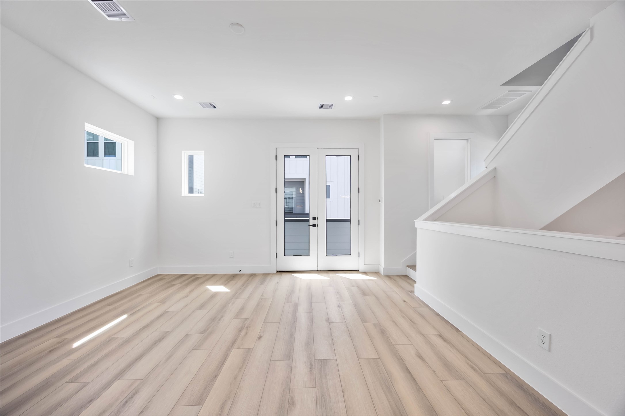 6735 Peerless Street, Unit C Houston, TX 77021 - Photo 5 of 27 a view of an empty room with wooden floor and a window