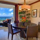 a view of a dining room with furniture a chandelier and wooden floor